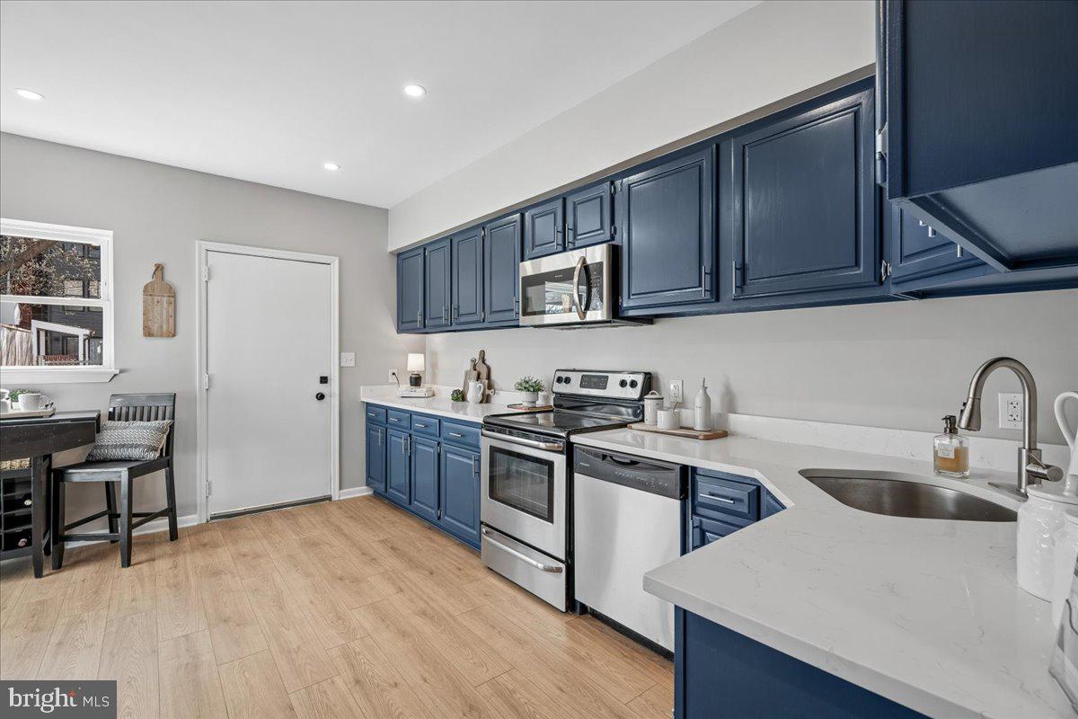 817 4th Street Northeast Washington, DC 20002 - Photo 12 of 40 a kitchen with stainless steel appliances granite countertop a sink stove and refrigerator