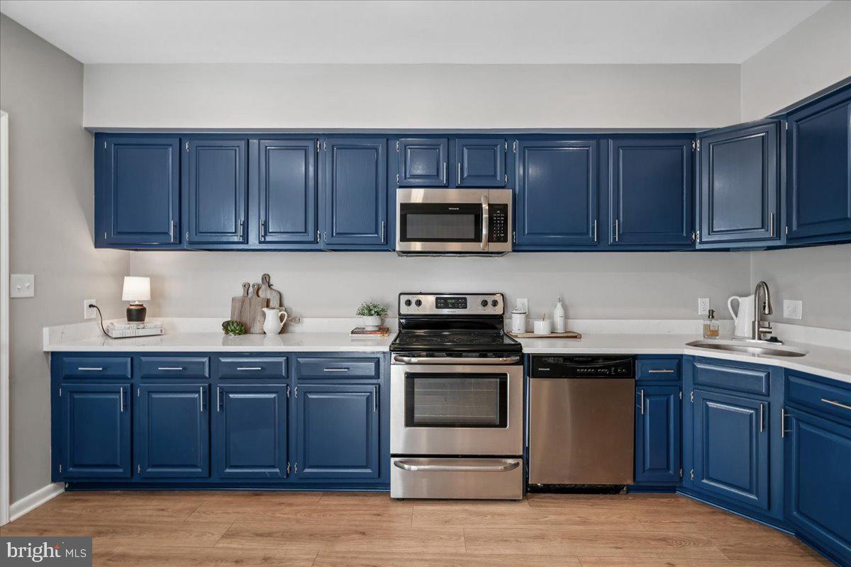 817 4th Street Northeast Washington, DC 20002 - Photo 13 of 40 a kitchen with sink cabinets and stainless steel appliances