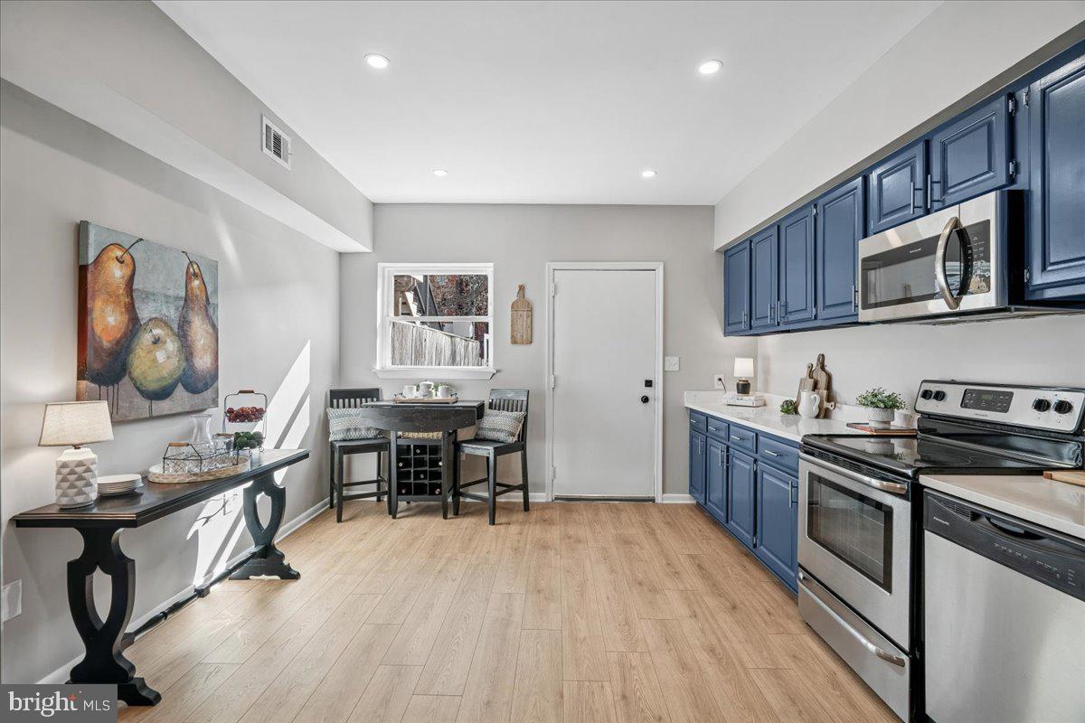 817 4th Street Northeast Washington, DC 20002 - Photo 15 of 40 a kitchen with stainless steel appliances granite countertop a stove top oven a sink dishwasher and cabinets with wooden floor