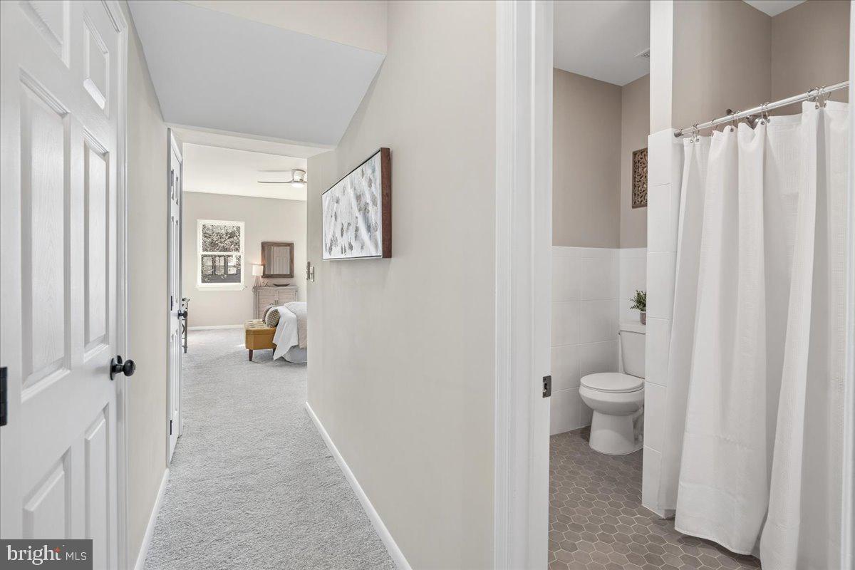 817 4th Street Northeast Washington, DC 20002 - Photo 19 of 40 a bathroom with a toilet a sink and curtain