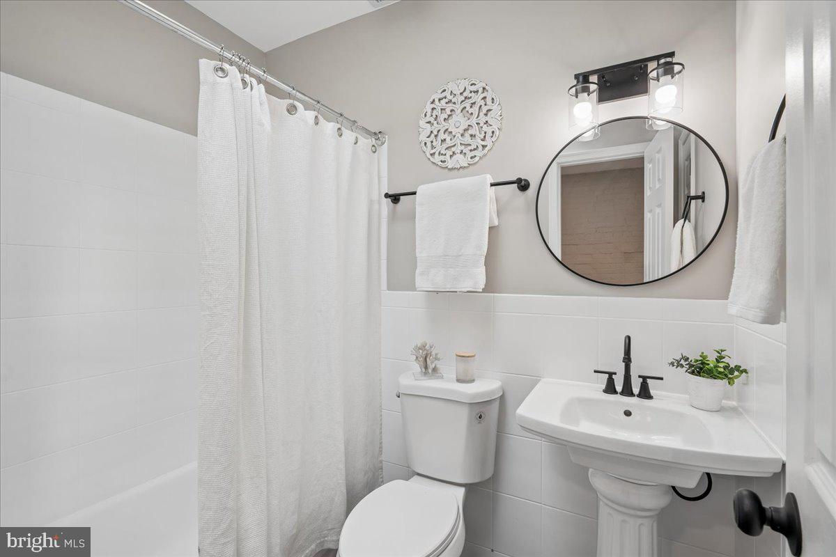 817 4th Street Northeast Washington, DC 20002 - Photo 32 of 40 a bathroom with a toilet sink and mirror