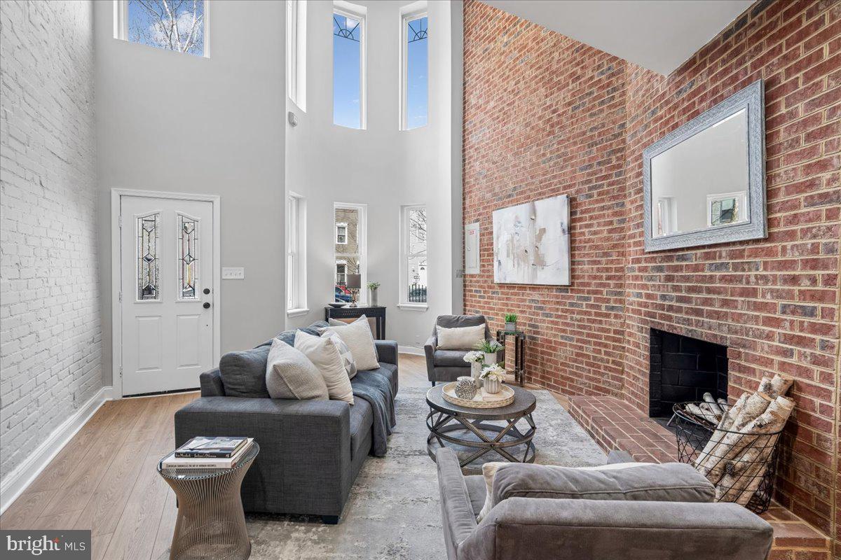 817 4th Street Northeast Washington, DC 20002 - Photo 4 of 40 a living room with furniture a fireplace and a table