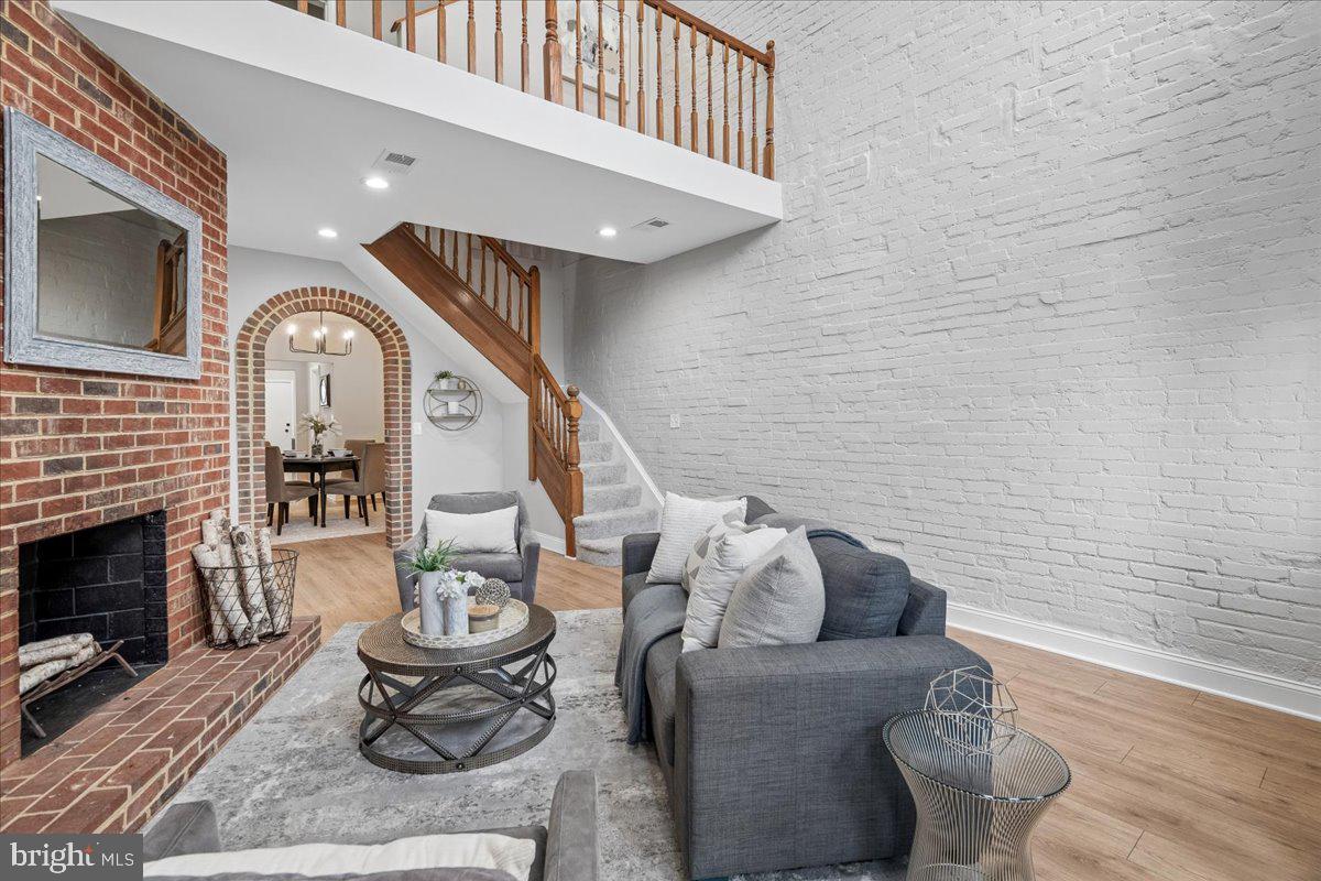 817 4th Street Northeast Washington, DC 20002 - Photo 7 of 40 a living room with furniture and a fireplace
