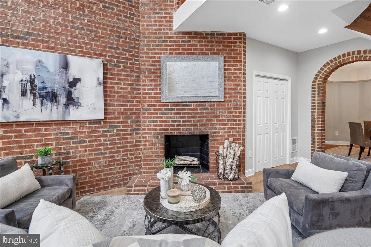 817 4th Street Northeast Washington, DC 20002 - Photo 8 of 40 a living room with furniture and a fireplace