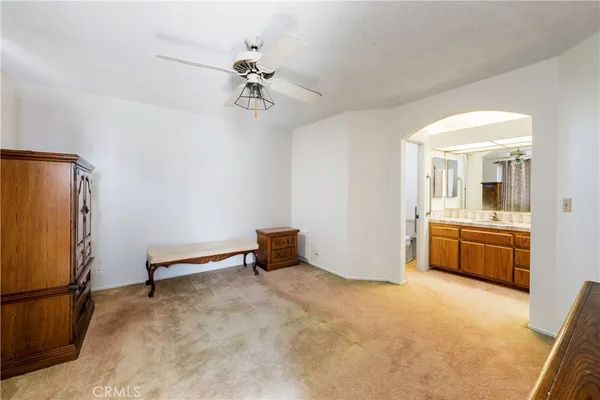a view of a livingroom with a furniture and a ceiling fan