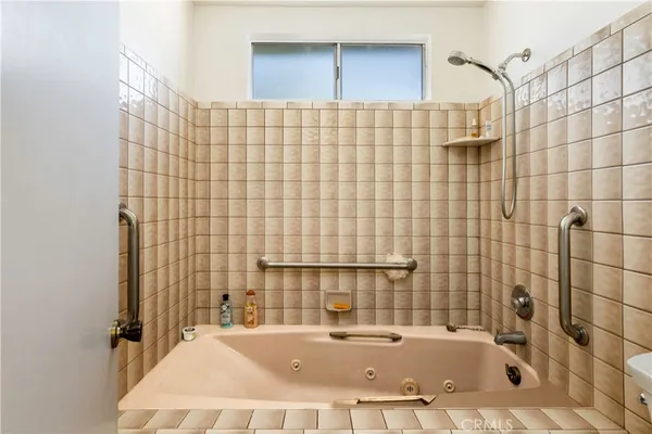 a bathroom with a bathtub and shower