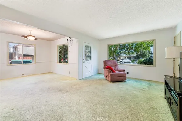a living room with furniture and large windows