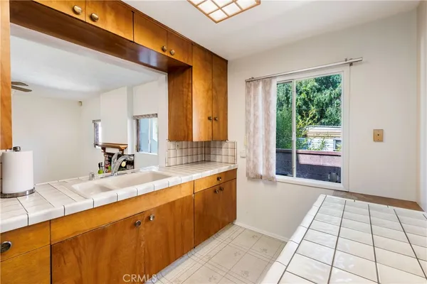 a large white kitchen with a large window