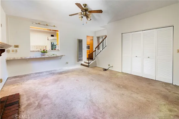a view of a livingroom with a furniture and a ceiling fan