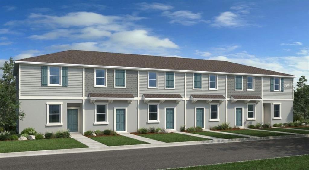 a front view of a house with yard and trees