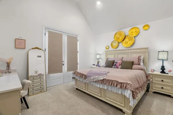a bedroom with a bed and painting on the wall