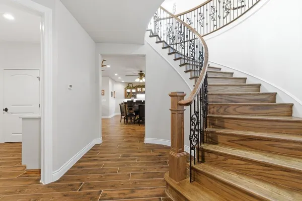 a view of entryway and hall with wooden floor