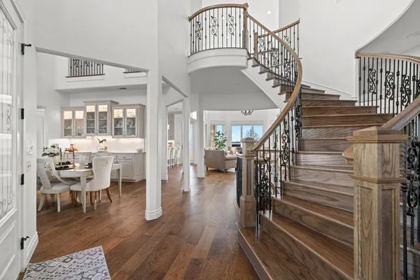 a view of entryway and hall with wooden floor