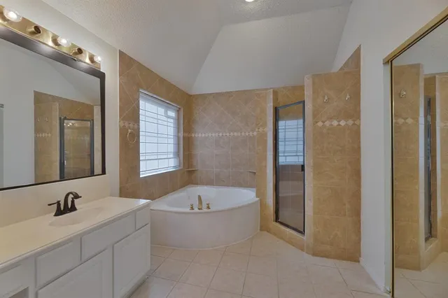 a bathroom with a bathtub sink and mirror