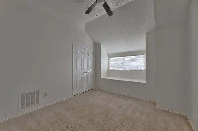 an empty room with a empty space and windows