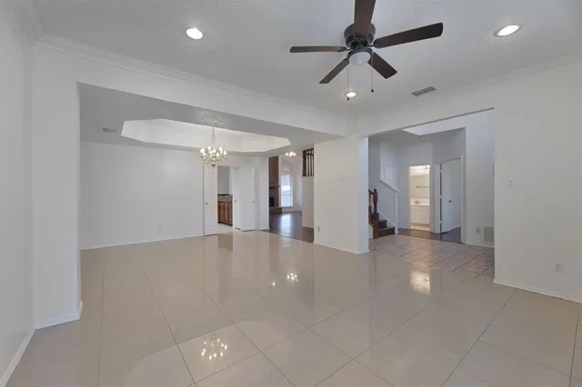 a view of a livingroom with a ceiling fan and window
