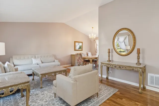 a living room with furniture a clock and a rug