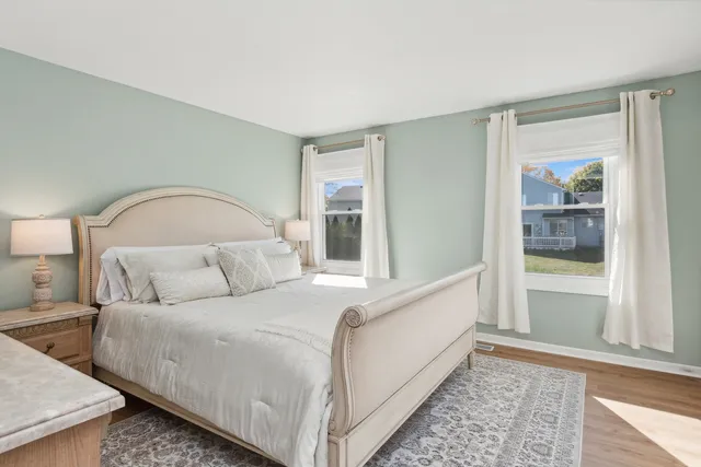 a living room with a bed furniture and next to a window