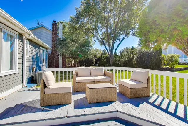a view of a swimming pool with a porch and furniture