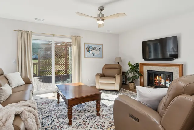 a living room with furniture a fireplace and a flat screen tv