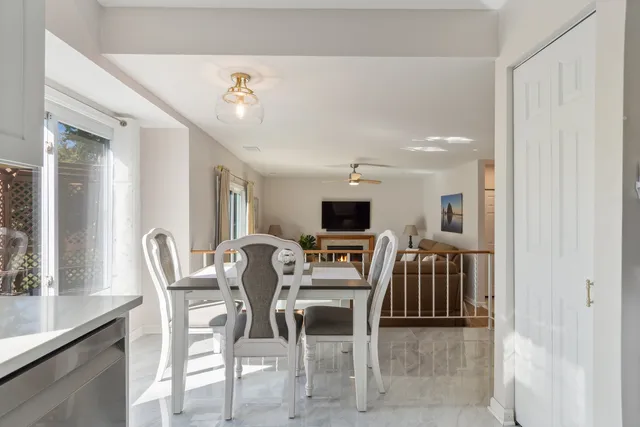 a dining room with furniture and a flat screen tv