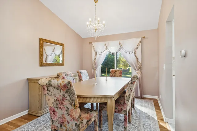 a view of a dining room with furniture and a chandelier