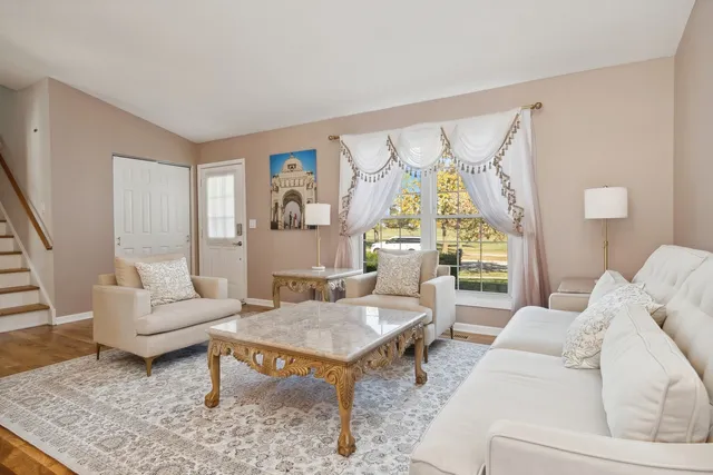 a living room with furniture and a large window