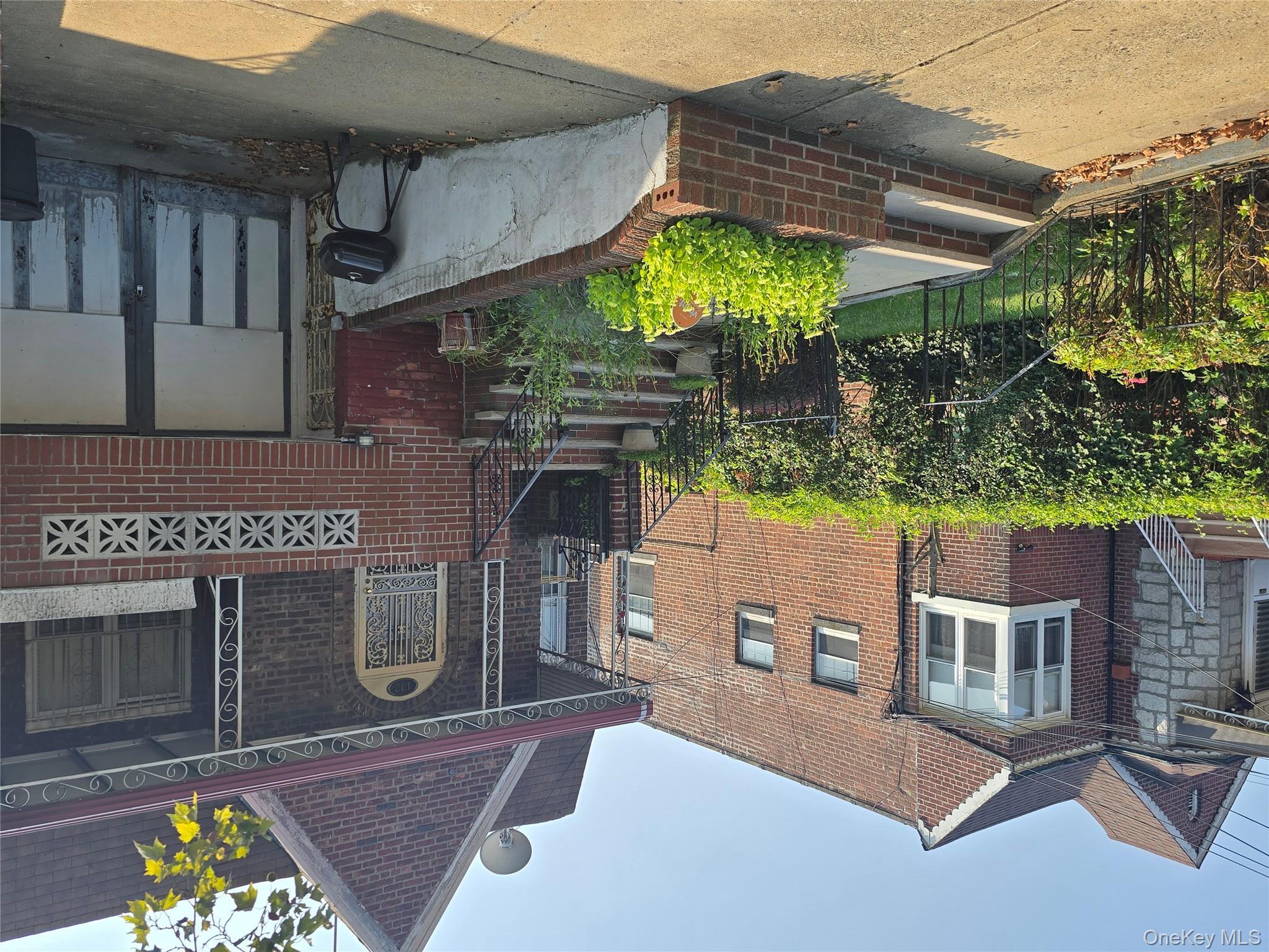 142 East 88th Street Brooklyn, NY 11236 - Photo 8 of 14 a front view of a house with a garden