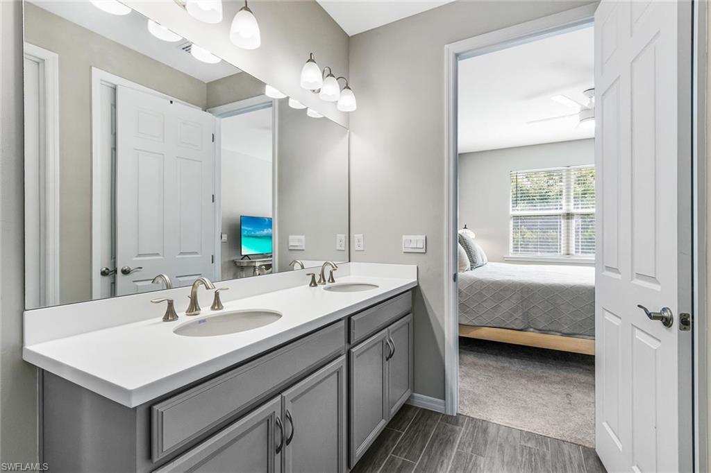 1252 Enbrook Loop Naples, FL 34114 - Photo 13 of 26 a en suite bathroom with 2 sink and a mirror