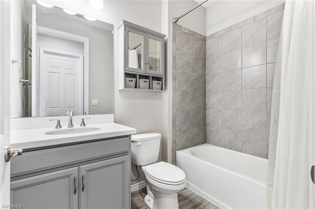 1252 Enbrook Loop Naples, FL 34114 - Photo 15 of 26 a bathroom with a sink a toilet and shower