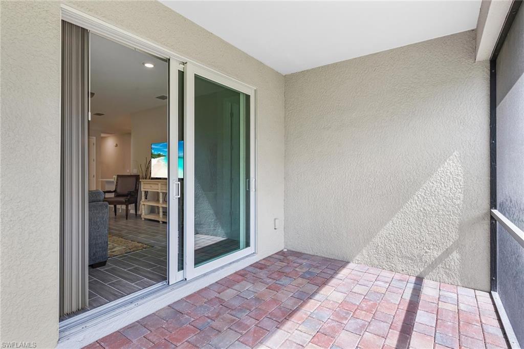 1252 Enbrook Loop Naples, FL 34114 - Photo 20 of 26 a view of a hallway with wooden floor and a living room