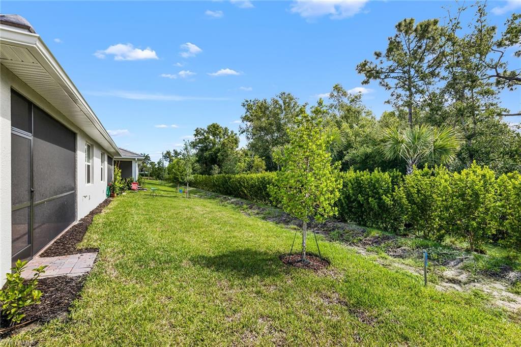 1252 Enbrook Loop Naples, FL 34114 - Photo 22 of 26 a backyard of a house with lots of green space