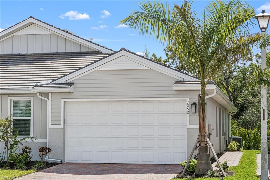 1252 Enbrook Loop Naples, FL 34114 - Photo 26 of 26 a view of house with a yard and potted plants