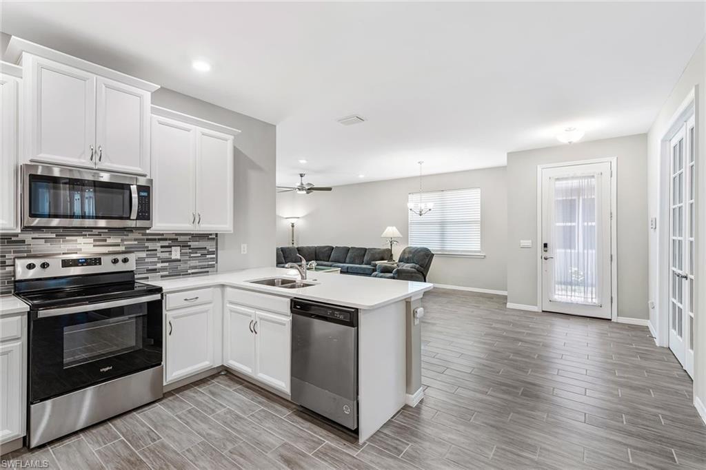 1252 Enbrook Loop Naples, FL 34114 - Photo 3 of 26 a kitchen with a stove and a microwave