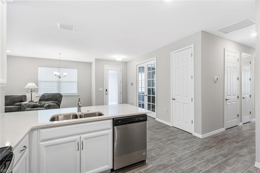 1252 Enbrook Loop Naples, FL 34114 - Photo 4 of 26 a room with kitchen island a sink and wooden floor