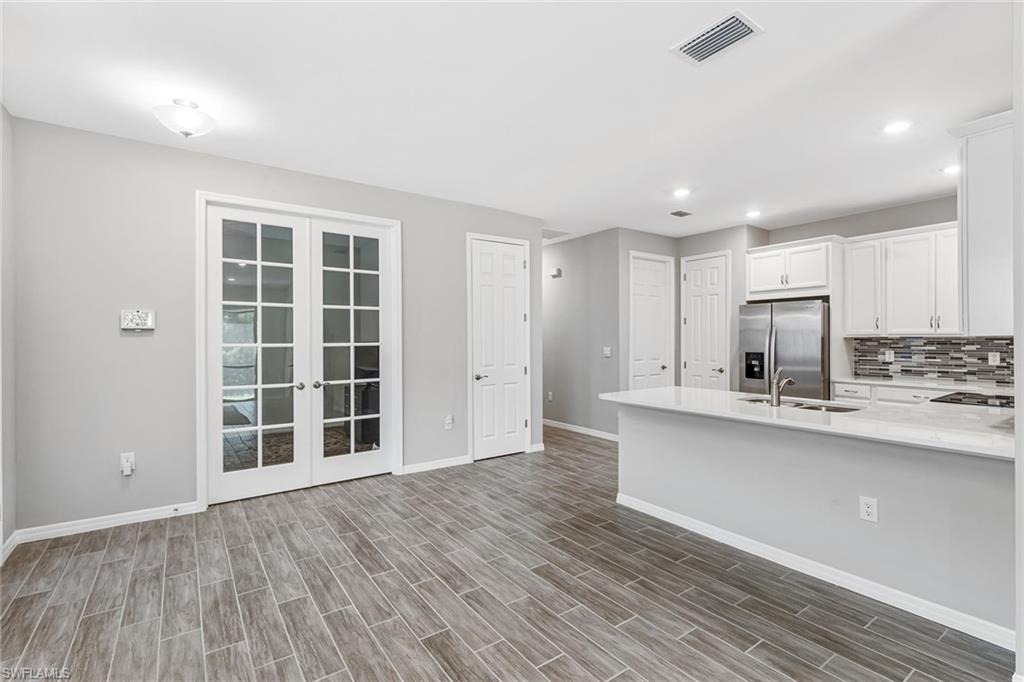 1252 Enbrook Loop Naples, FL 34114 - Photo 6 of 26 a view of kitchen with wooden floor and sink