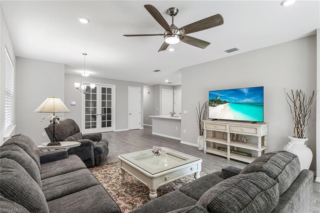 1252 Enbrook Loop Naples, FL 34114 - Photo 7 of 26 a living room with furniture and a flat screen tv