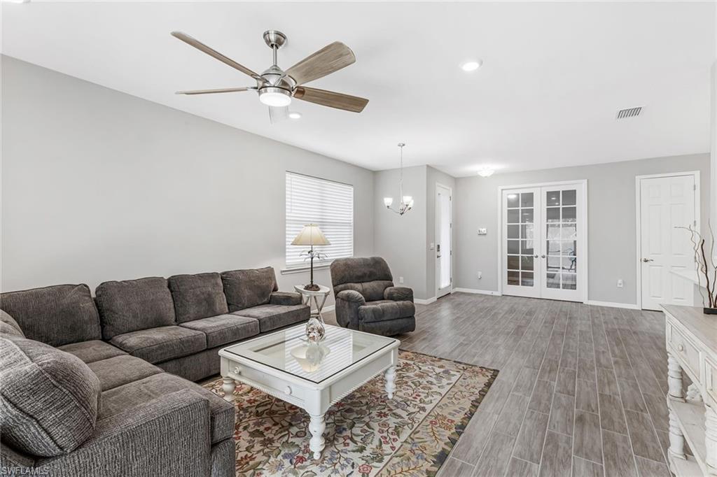 1252 Enbrook Loop Naples, FL 34114 - Photo 8 of 26 a living room with furniture ceiling fan and a rug