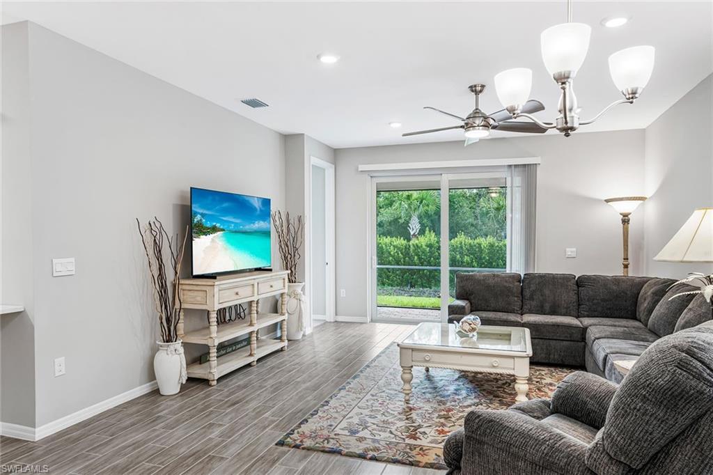 1252 Enbrook Loop Naples, FL 34114 - Photo 10 of 26 a living room with furniture and a flat screen tv