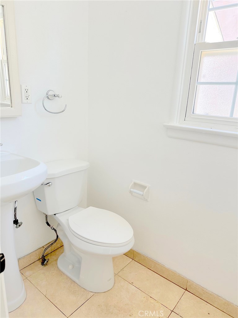 14722 Addison Street Sherman Oaks, CA 91403 - Photo 13 of 22 a white toilet sitting next to a bathroom sink