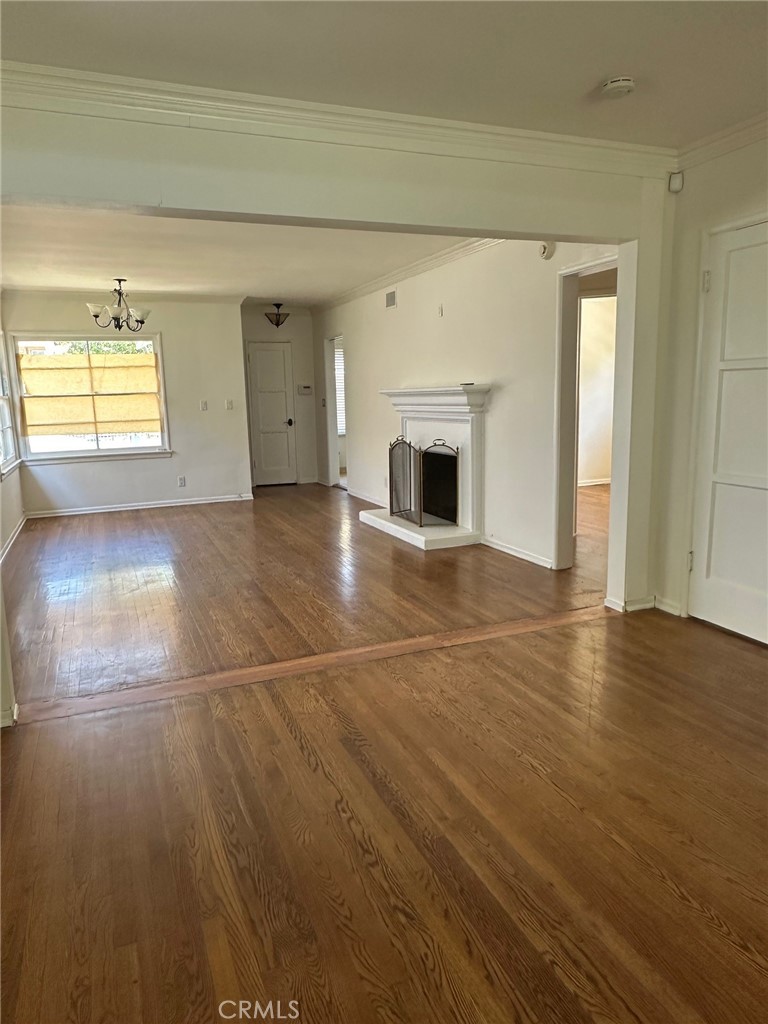 14722 Addison Street Sherman Oaks, CA 91403 - Photo 19 of 22 a view of empty room with wooden floor and fireplace