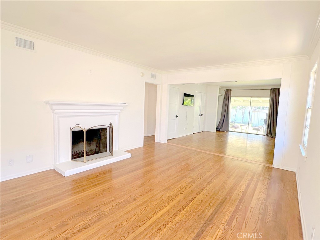 14722 Addison Street Sherman Oaks, CA 91403 - Photo 3 of 22 a view of empty room with wooden floor and fireplace