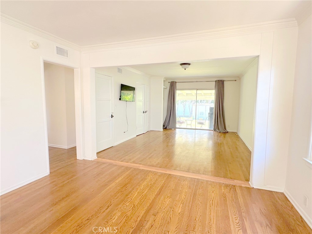 14722 Addison Street Sherman Oaks, CA 91403 - Photo 4 of 22 a view of an empty room with wooden floor and a window