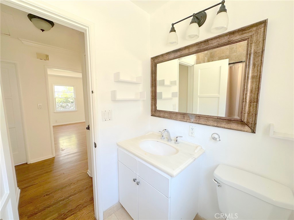 14722 Addison Street Sherman Oaks, CA 91403 - Photo 7 of 22 a bathroom with a sink a toilet and a mirror