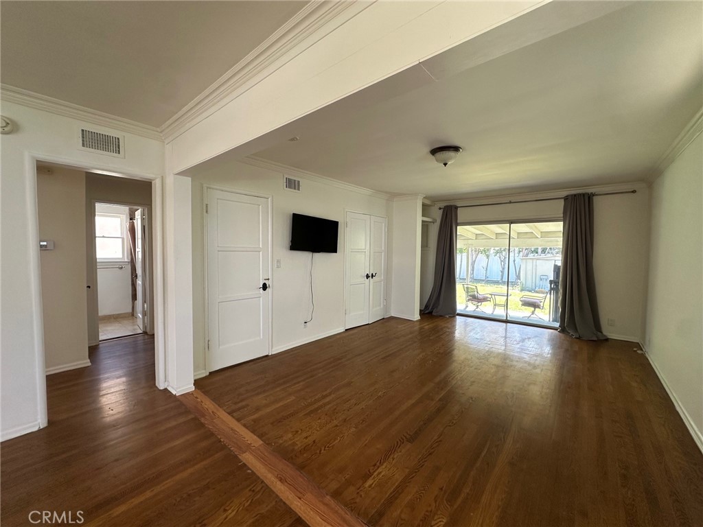 14722 Addison Street Sherman Oaks, CA 91403 - Photo 8 of 22 a view of an empty room with wooden floor and a window