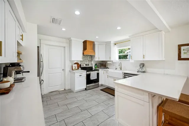 a kitchen with a sink stove top oven and cabinets