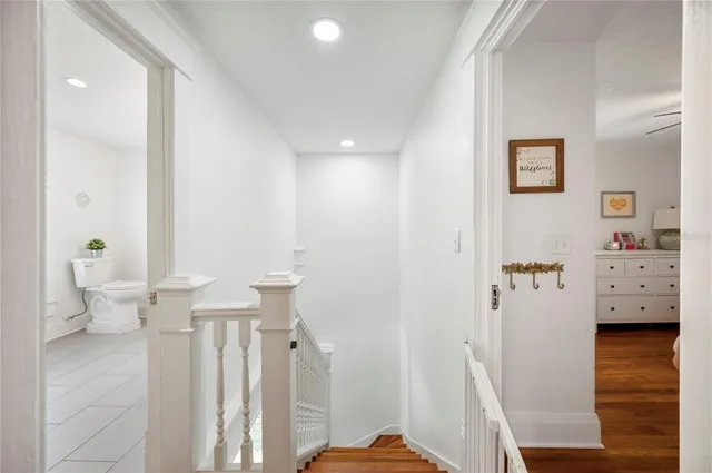 a bedroom with a bed a flat screen tv and a couch