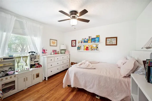 a bedroom with a bed and a book shelf