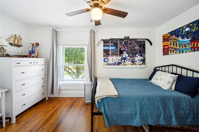 a bedroom with furniture and a wooden floor