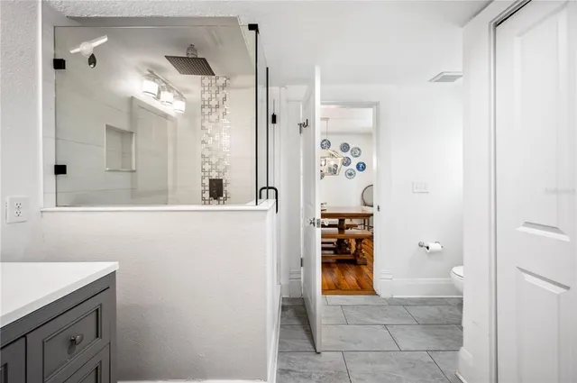 a view of a backyard with a garden and entertaining space